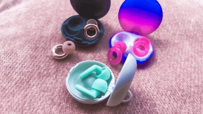 Loop earplugs in colorful cases, showcasing different designs and sizes for comfortable wearing.